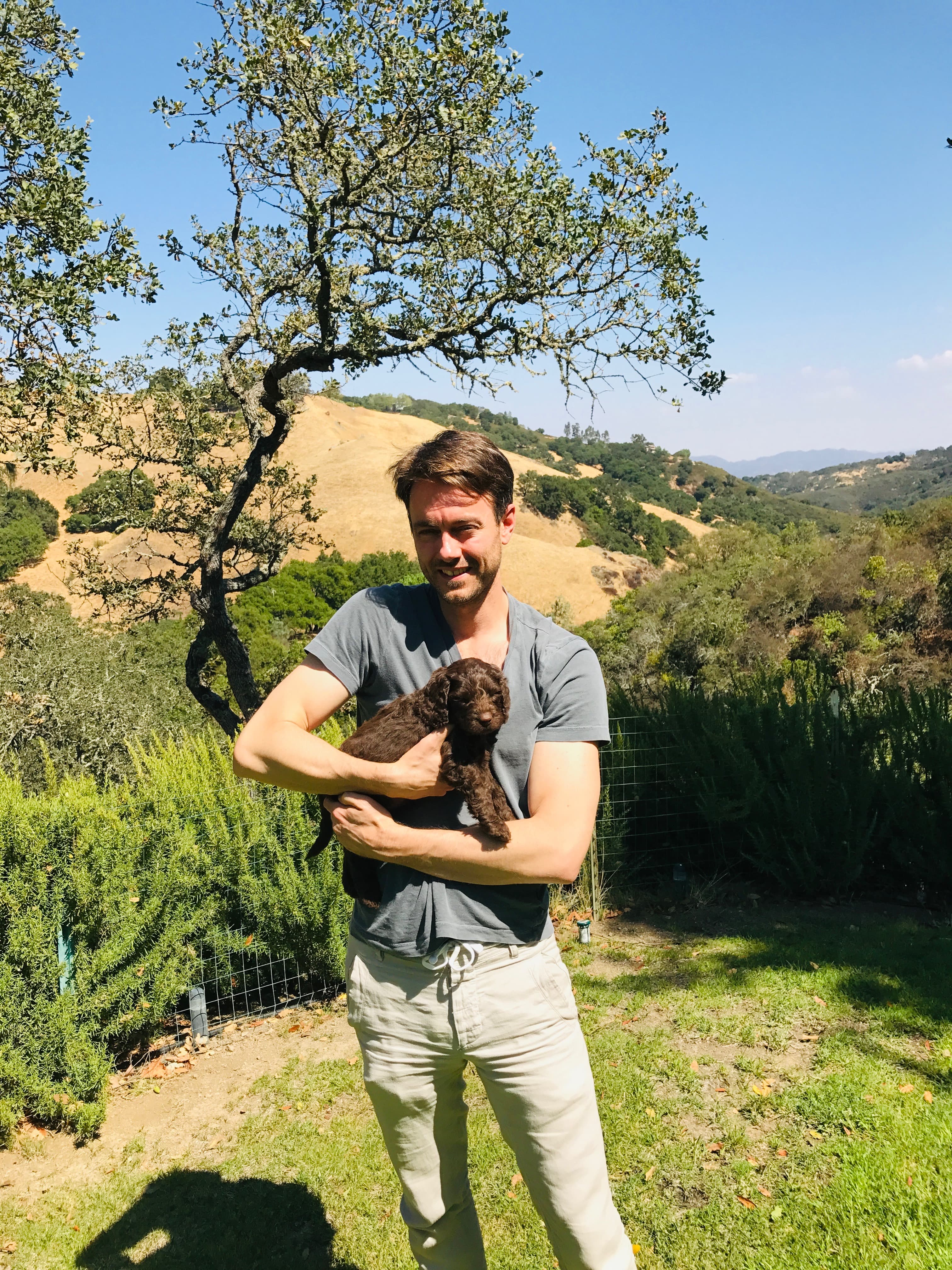 Ned as a puppy being held in San Luis Obispo hills